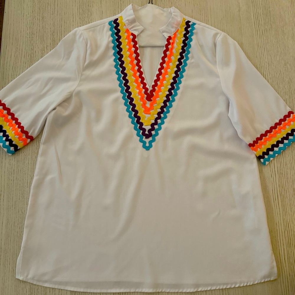 Mazic brand white top with colorful accents